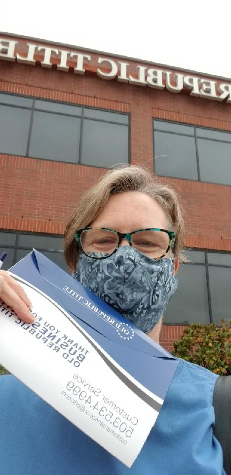 A selfie from our buyer, excitedly holding up her signing documents