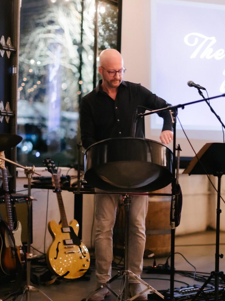 Yascha Noonberg playing steel drum at a corporate event